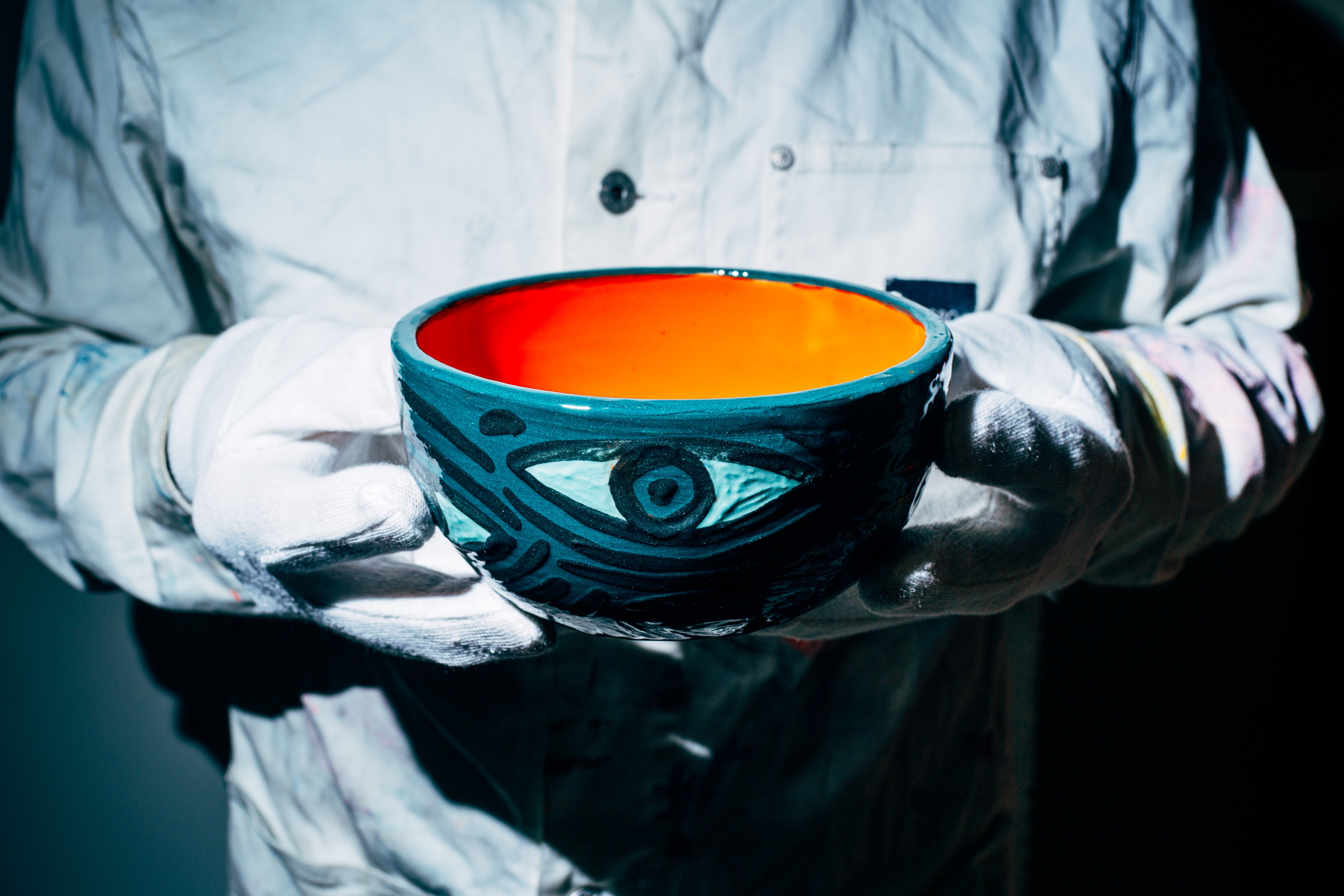 The Bowl of Wisdom -- handpainted ceramic bowl with eye motifs in petrol-green-blue, orange interior, 2025