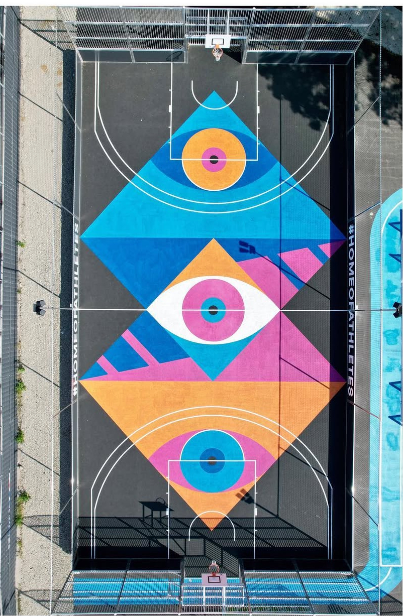 Aerial view of a basketball court painted by SuperBlast with colorful geometric eye motifs, Sports Base Berlin, 2018